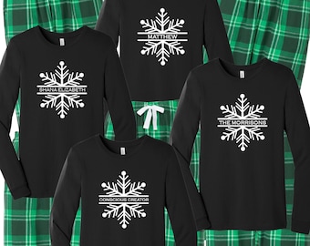 May include: Four sets of black long-sleeve shirts and green plaid pants. Each shirt features a white snowflake graphic with a horizontal line through the center containing the text SHANA ELIZABETH, MATTHEW, THE MORRISONS, or CONSCIOUS CREATOR.