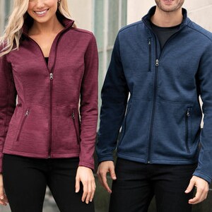May include: Two people wearing zippered jackets. The person on the left is wearing a burgundy jacket and the person on the right is wearing a navy blue jacket.