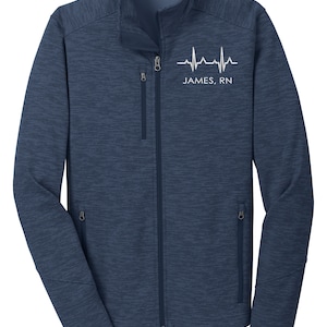 May include: A navy blue fleece jacket with a zipper closure and two zippered pockets. The jacket has a white heartbeat graphic and the text "JAMES, RN" on the front.