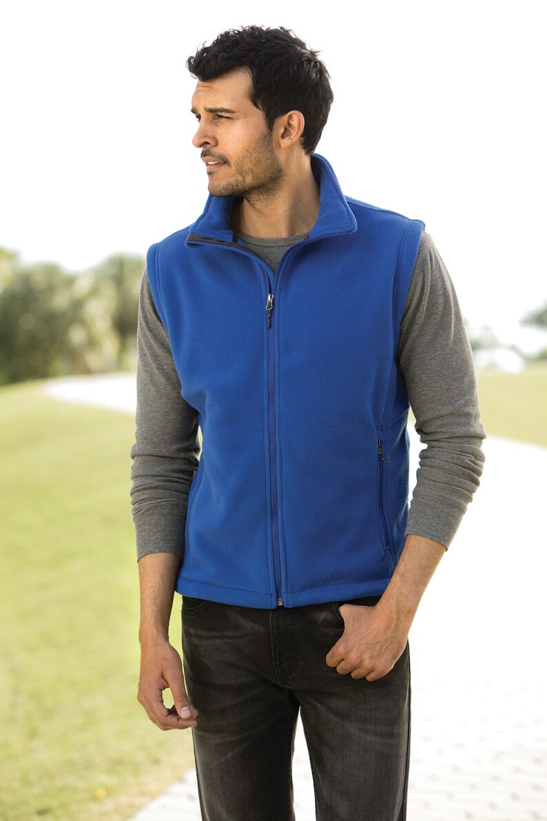May include: A blue fleece vest with a zipper closure and two pockets. The vest is made of a soft, comfortable material and has a relaxed fit.