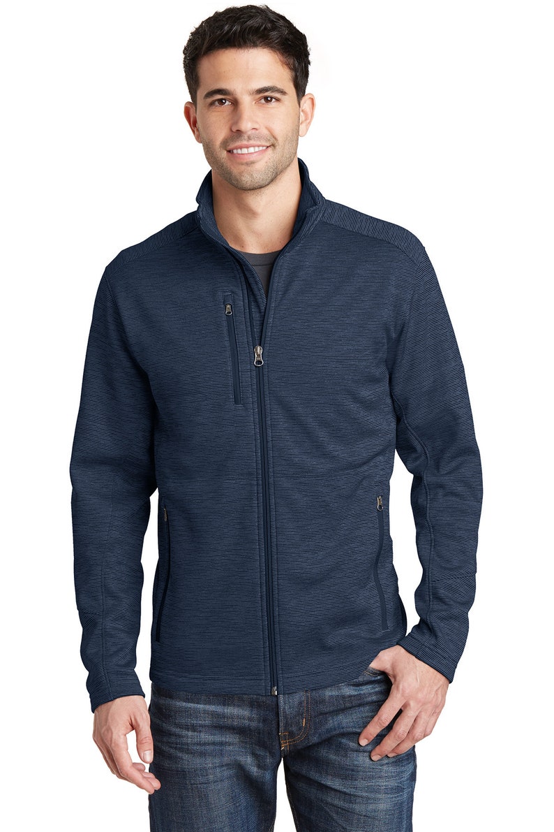 May include: A navy blue zip-up jacket with a textured pattern. The jacket has two zippered pockets on the front and a stand-up collar.