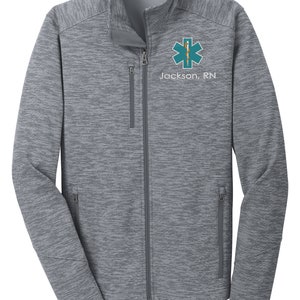 May include: A gray heather zip-up jacket with a teal star of life and the text "Jackson, RN" embroidered on the left chest.