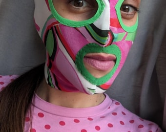 Psychedelic pink and green print fabric mask.