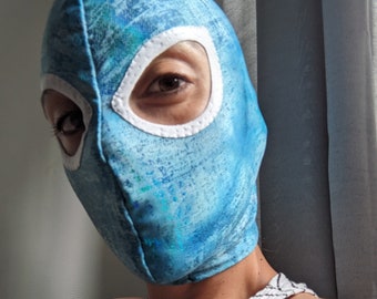 Blue textured shiny mask with grey cat eyes openings.