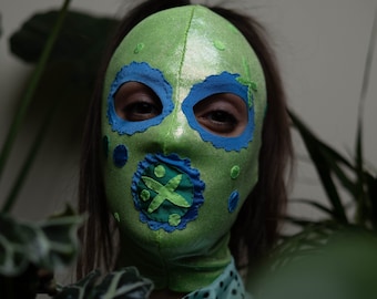 Shiny green hood with ponytail hole. Blue and green details