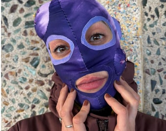 Purple tie dye stretchy fabric mask with bumps decorated with pearls.