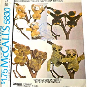 May include: Vintage McCall's 5830 sewing pattern for a set of stuffed animals. The pattern features illustrations of various plush toy animals, including bears and koalas, perched on tree branches. The pattern includes instructions for easy Velcro fasteners.