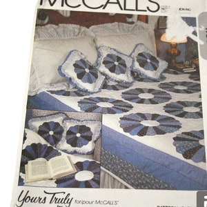 May include: A McCall's sewing pattern for a quilt with a blue and white floral design. The pattern number is 8426 and the price is £4.60. The pattern is called "Yours Truly" for McCall's.