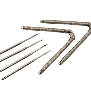 May include: A set of silver nutcrackers with intricate designs. The set includes two nutcrackers and five nut picks.