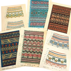 May include: A collection of vintage knitting pattern charts, featuring colorful geometric designs. The charts are printed on aged paper, showcasing various patterns in blue, green, red, and brown. The designs appear to be for sweaters or skirts.