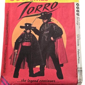 Peut inclure: Un patron de couture vintage McCall's Costumes pour un costume de Zorro. Le patron est pour un adulte et un enfant, et comprend un masque noir, une cape et une épée. Le patron est étiqueté "6689 Ex-Large" et "Tres Grande Pattern/Patron". Le texte "...la légende continue..." est imprimé au bas du patron.