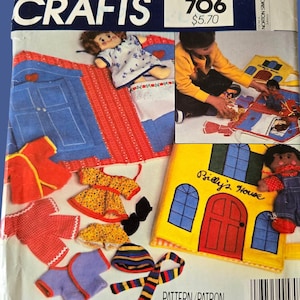 May include: A McCall's Crafts sewing pattern envelope for Billy's House and Mindy's House, featuring illustrations of fabric dollhouses, beds, closets, and wardrobes. The cover displays a yellow house labeled Billy's House and various small doll clothes in red, yellow, and purple.