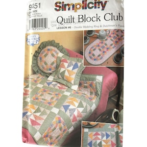 May include: Quilt Block Club lesson #6 pattern from Simplicity. The pattern includes instructions for making a table runner, cushion, and quilt using a double wedding ring and Dutchman's puzzle block design.