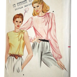 May include: Vintage Butterick sewing pattern, size 12, featuring illustrations of two women's blouses and pants. The pattern cover has the text "BUTTERICK" and "3561". The price is $2.45.