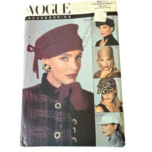 May include: Vogue Accessories pattern 8211 for a hat. The pattern includes five different hat styles: a burgundy turban, a brown turban, a leopard print visor, a brown visor, and a white visor. The pattern is for one size.