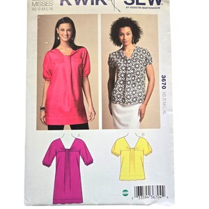 May include: Sewing pattern for a women's top with a V-neck and short sleeves. The pattern includes three different styles: a pink top with a gathered neckline, a yellow top with a gathered neckline, and a pink top with a gathered neckline and a longer length. The pattern is from Kwik Sew and is designed by Kerstin Martensson. The pattern number is 3670.