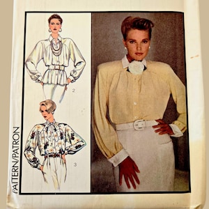 May include: Vintage Style sewing pattern with illustrations of blouses and a skirt. The pattern includes a size 14, with the word "Style" in red script. The pattern is for a blouse and skirt.