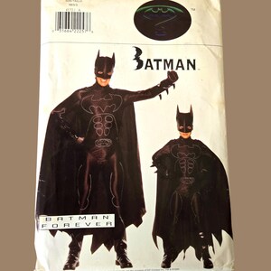 May include: A Butterick pattern for a Batman costume. The package shows images of the Batman character in a black costume with a cape. The package has the Batman logo and the words "Batman Forever".