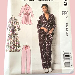 May include: McCall's M7875 sewing pattern for pyjamas and robes. The pattern features illustrations of various pyjama and robe styles, including a floral print robe, a pink robe, and pyjama trousers. The size is Y (XSM-SML-MED).