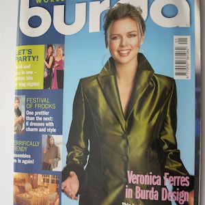 May include: A magazine cover featuring Veronica Ferres wearing a green satin jacket with black fur trim. The magazine is titled "Burda" and the cover text reads "Veronica Ferres in Burda Design".