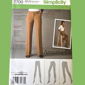 May include: Simplicity sewing pattern 2700 for pants. The pattern features a photo of the finished pants, along with diagrams for slim, average, and curvy fits. The pattern includes sizing information in US and European sizes.