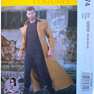 May include: McCall's Costumes sewing pattern M7374 for a long, tan trench coat with a wide collar. The pattern envelope features a photograph of a person wearing the coat over a dark shirt and pants, with the Yaya Han logo and size range MWW 38-44.