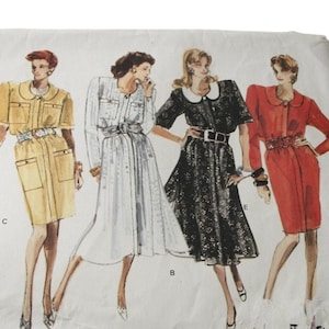 May include: Vintage Vogue Basic Design sewing pattern 2103. The pattern envelope features illustrations of five different dress designs. The text on the envelope includes "Vogue's Basic Design", "PATTERN/PATRON 2103", and "EASY/FACILE".