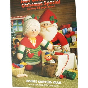 May include: A Christmas-themed book cover featuring knitted figures of Santa Claus and a woman, with the text "Jean Greenhowe's Christmas Special." The cover also includes a knitted doll in a sack and a basket of yarn.