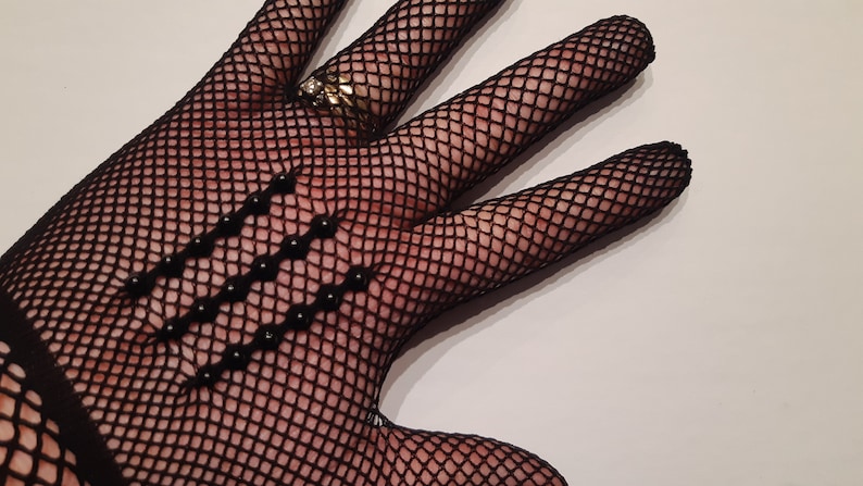 May include: Black fishnet gloves with black bead embellishments.