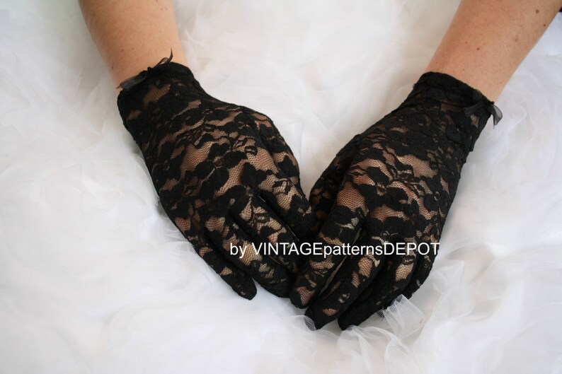 May include: A pair of black lace gloves with a small bow at the wrist.