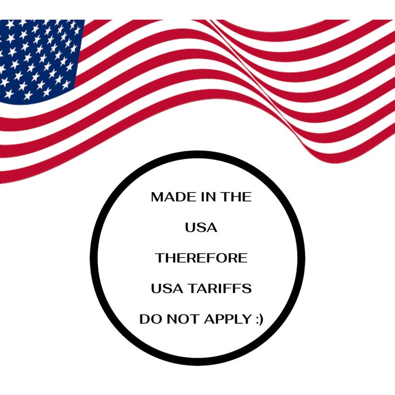 May include: The image shows the American flag waving in the background. A black circle contains the text "MADE IN THE USA THEREFORE USA TARIFFS DO NOT APPLY :)". The flag has red and white stripes and a blue field with white stars.