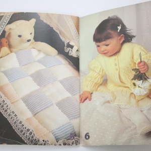 May include: A white ceramic mug with a black handle and the text "But First, Coffee" in a black, bold font. The mug is on a wooden surface. The mug is approximately 10 cm tall.