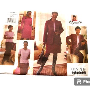 May include: A Vogue Wardrobe sewing pattern featuring a woman in a burgundy suit, a pink dress, and a pink top with a skirt or pants. The pattern includes multiple views of the outfits. The pattern number is 2597.