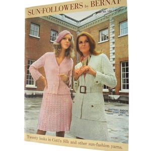 May include: A vintage knitting pattern booklet titled SUN-FOLLOWERS by BERNAT, featuring two models wearing knit garments. The cover displays a pink two-piece set and a white belted jacket with a skirt, set against a brick building background.