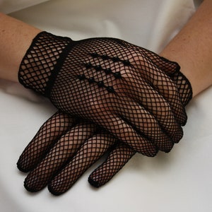 May include: A pair of black fishnet gloves with a diamond pattern.