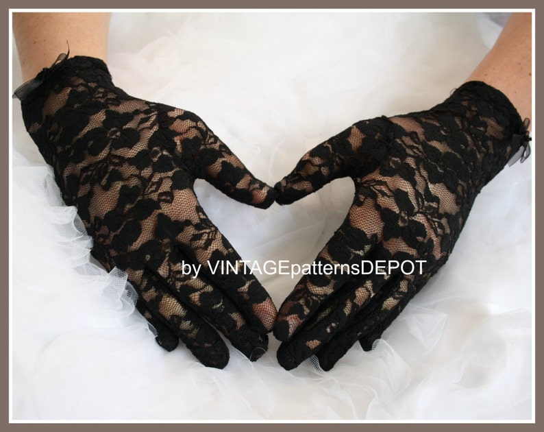 May include: A pair of black lace gloves with a floral pattern. The gloves are shown against a white background.