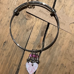 Adjustable steel bangle with Vintage tin charm