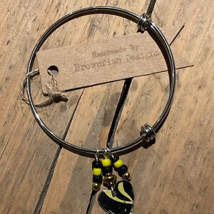 Adjustable steel bangle with Vintage tin charm