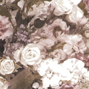 May include: A close-up of a floral arrangement featuring roses and other flowers in shades of white, cream, and mauve. The image has a vintage, slightly faded aesthetic, with soft focus and a painterly quality. The flowers are densely packed.