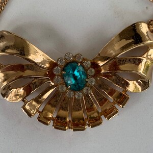 Vintage Bow Centered w/ Chain Necklace Enhanced w/ Center Blue Rhinestone Surrounded w/ White Rhinestones