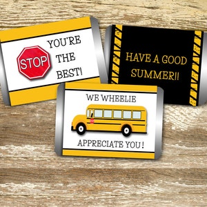 May include: Three candy bar wrappers with school-themed designs. One has a stop sign and the text "YOU'RE THE BEST!". Another says "HAVE A GOOD SUMMER!!". The third features a yellow school bus and the text "WE WHEELIE APPRECIATE YOU!"