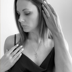 Žaltys Snake Necklace and single, double, and triple wrapped Žaltys Snake Rings on designer Jorie Breonn.