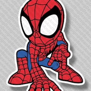 May include: A cartoon sticker of Spider-Man in a crouching pose, pointing forward. The character is depicted in his classic red and blue suit with a black web pattern and white eyes. The sticker has a white border.