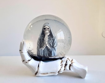 Halloween Praying Skeleton Snow Globe Mounted on Skeleton Hand Base