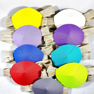 May include: Set of ten eye patches in various colors, including yellow, purple, blue, red, green, and gray. Each patch is attached to an elastic band.