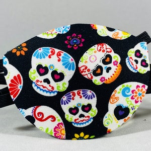 May include: Black eye patch with a colorful sugar skull pattern. The patch has an elastic strap for a comfortable fit.