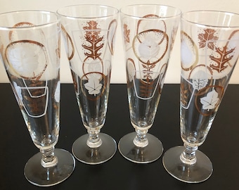 May include: Set of four clear glass beer mugs with a gold and white leaf design.
