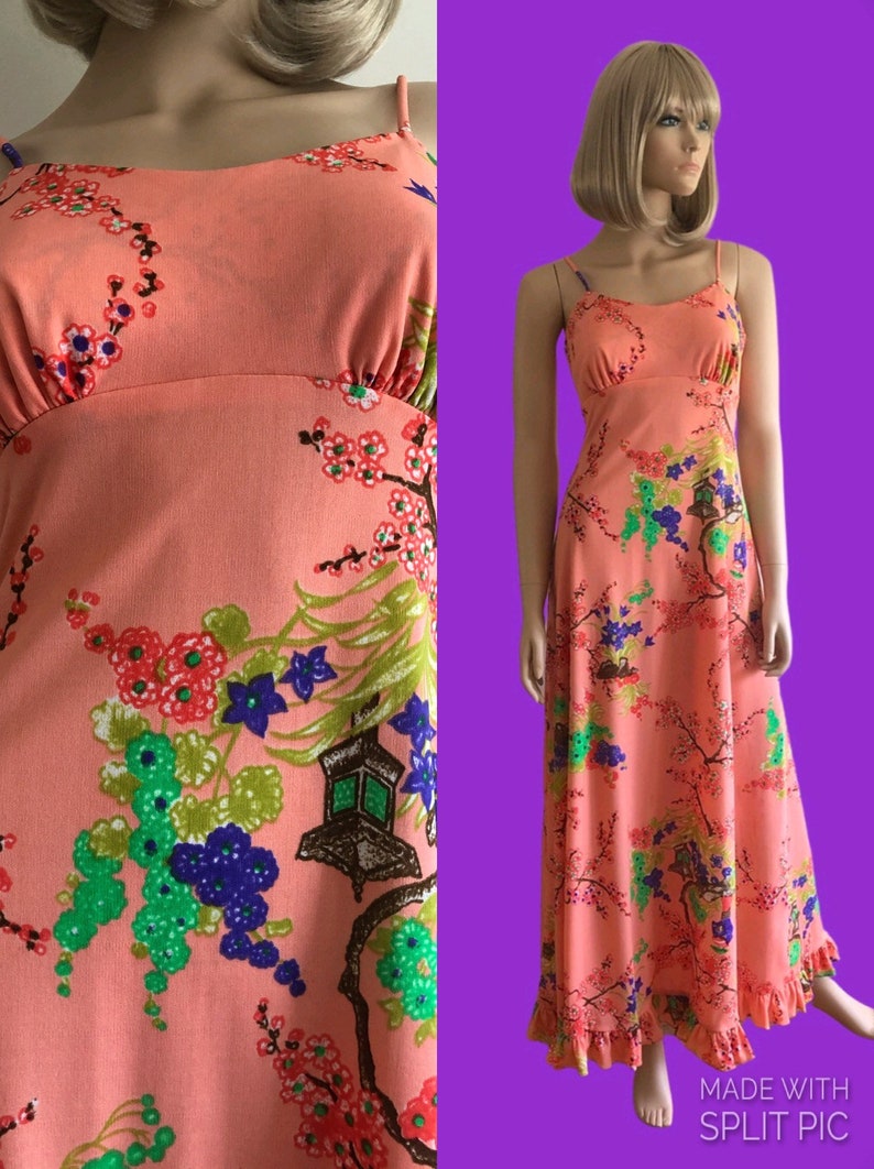May include: A long, peach-colored maxi dress with a floral print featuring cherry blossoms, lanterns, and green leaves. The dress has thin straps and a ruffled hem.