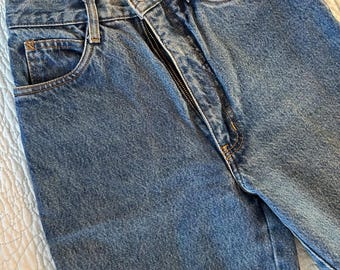 May include: A pair of blue denim jeans with a zipper fly and a button closure. The jeans have a classic five-pocket style.