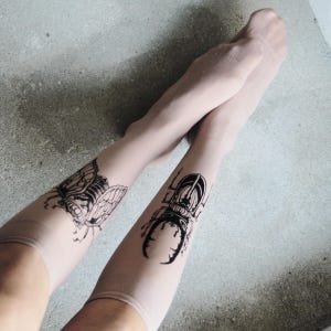 Hand-painted tattoo socks featuring intricate cicada and beetle artwork, perfect for entomology lovers, bug enthusiasts, and goblincore fashion. These unique, nature-inspired socks create a realistic tattoo illusion, combining art and style in wearable form. A thoughtful and quirky insect-themed gift for those who appreciate novelty and handcrafted designs.